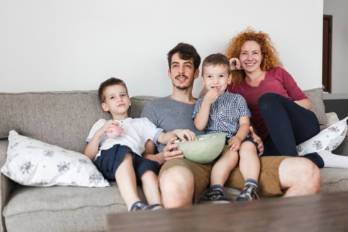 happy-family-sitting-sofa-watching-television_23-2147909519 (1)